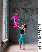 beautiful gymnast woman dancing with pink ribbon. Стоковое фото, агентство Ingram Publishing / Фотобанк Лори