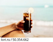 glass coke with ice hand beach. Стоковое фото, агентство Ingram Publishing / Фотобанк Лори