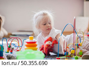 charming kid with educational toys. Стоковое фото, агентство Ingram Publishing / Фотобанк Лори