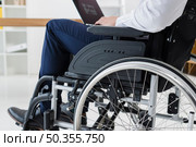 close up businessman sitting wheelchair using laptop. Стоковое фото, агентство Ingram Publishing / Фотобанк Лори