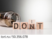 dont word with jar with coins. Стоковое фото, агентство Ingram Publishing / Фотобанк Лори