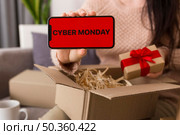 high angle woman unboxing cyber monday package. Стоковое фото, агентство Ingram Publishing / Фотобанк Лори