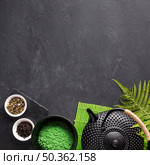 dried tea herb green matcha tea powder with teapot black textured background. Стоковое фото, агентство Ingram Publishing / Фотобанк Лори