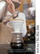 front view female barista straining coffee. Стоковое фото, агентство Ingram Publishing / Фотобанк Лори