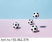 front view footballs bouncing around. Стоковое фото, агентство Ingram Publishing / Фотобанк Лори