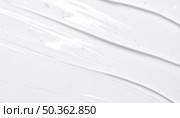 Minimalist texture of white liquid or cream symbolizing beauty product, skincare, wellness or smooth cosmetic formulation. Стоковое AI-изображение, AI-художник Igor Tichonow / Фотобанк Лори