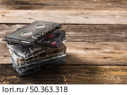stack transparent cassette tapes wooden background. Стоковое фото, агентство Ingram Publishing / Фотобанк Лори