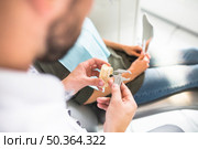 dentist measuring plastic teeth model with vernier caliper. Стоковое фото, агентство Ingram Publishing / Фотобанк Лори