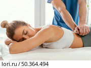 front view male osteopathic therapist checking female patient s lower back spine. Стоковое фото, агентство Ingram Publishing / Фотобанк Лори