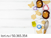 animal shaped cookies with kitchen utensils wooden table. Стоковое фото, агентство Ingram Publishing / Фотобанк Лори
