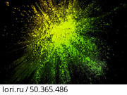 bright yellow powder holi color splatted backdrop. Стоковое фото, агентство Ingram Publishing / Фотобанк Лори