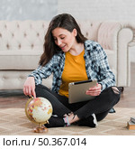 smart young student using world globe. Стоковое фото, агентство Ingram Publishing / Фотобанк Лори