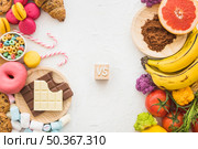 unhealthy versus healthy foods white surface. Редакционное фото, агентство Ingram Publishing / Фотобанк Лори