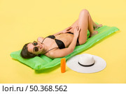 beautiful female lying inflatable mattress. Стоковое фото, агентство Ingram Publishing / Фотобанк Лори