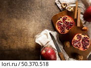 top view autumn pomegranates with copy space cinnamon sticks. Стоковое фото, агентство Ingram Publishing / Фотобанк Лори