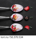 top view collection spoons with yogurt fruits. Стоковое фото, агентство Ingram Publishing / Фотобанк Лори