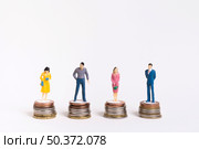 business man woman sitting equal piles coins. Стоковое фото, агентство Ingram Publishing / Фотобанк Лори