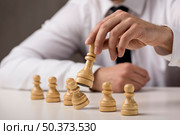 businessman tumbling pawn with king. Стоковое фото, агентство Ingram Publishing / Фотобанк Лори