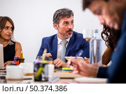 low angle coworkers meeting discussions. Стоковое фото, агентство Ingram Publishing / Фотобанк Лори