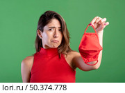 sad woman holding mask. Стоковое фото, агентство Ingram Publishing / Фотобанк Лори