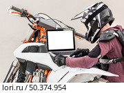 stylish rider trying diagnose motorbike problem. Стоковое фото, агентство Ingram Publishing / Фотобанк Лори