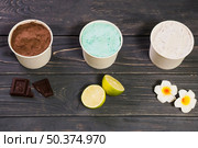 tasty neapolitan ice cream white containers. Стоковое фото, агентство Ingram Publishing / Фотобанк Лори