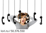 Beautiful woman in shock looking to a lot of telephones. Стоковое фото, агентство Ingram Publishing / Фотобанк Лори