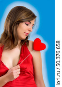 Valentine related pictures with a beautiful woman with a heart on the hands (blue background created on PS) Стоковое фото, агентство Ingram Publishing / Фотобанк Лори