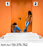 Loneliness woman and the other talking at the phone. Стоковое фото, агентство Ingram Publishing / Фотобанк Лори
