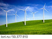 Beautiful green meadow with Wind turbines generating electricity. Стоковое фото, агентство Ingram Publishing / Фотобанк Лори
