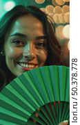 A woman with a green fan smiling in a dimly lit venue, fairy lights creating bokeh effects in background, music laser show on background. Стоковое AI-видео, аниматор Sergey Grishin / Фотобанк Лори