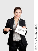Business woman holding a card board with the text message "Hire me" Стоковое фото, агентство Ingram Publishing / Фотобанк Лори