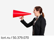Business young woman speaking to a megaphone, isolated on white. Стоковое фото, агентство Ingram Publishing / Фотобанк Лори