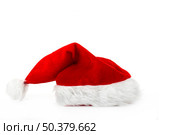 A red santa hat isolated on white background. Стоковое фото, агентство Ingram Publishing / Фотобанк Лори