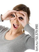 Funny portrait of a beautiful young woman doing gestures with hands - funny look. Стоковое фото, агентство Ingram Publishing / Фотобанк Лори