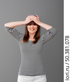 Woman smiling with hands in the head and covering eyes with her hair. Стоковое фото, агентство Ingram Publishing / Фотобанк Лори