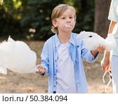 closeup kid holding cotton candy. Стоковое фото, агентство Ingram Publishing / Фотобанк Лори