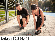 friends outdoor training bind their shoelaces. Стоковое фото, агентство Ingram Publishing / Фотобанк Лори