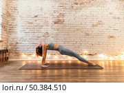 full shot senior woman stretching indoors. Стоковое фото, агентство Ingram Publishing / Фотобанк Лори