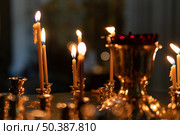 Candles burning in an Orthodox church. Стоковое фото, фотограф Олег Альбертович Потаскуев / Фотобанк Лори