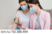 stay indoors women wearing medical masks. Стоковое фото, агентство Ingram Publishing / Фотобанк Лори