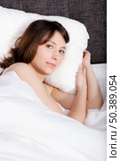 Porttrait of a beautiful and natural young girl on the bed. Стоковое фото, агентство Ingram Publishing / Фотобанк Лори