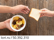 hand giving bowl food bread needy person. Стоковое фото, агентство Ingram Publishing / Фотобанк Лори