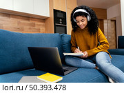 teenage girl with laptop headphones during online school. Стоковое фото, агентство Ingram Publishing / Фотобанк Лори