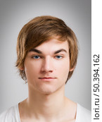 Portrait of a handsome young man, over a gray background. Стоковое фото, агентство Ingram Publishing / Фотобанк Лори