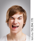 Portrait of a handsome young man, over a gray background. Стоковое фото, агентство Ingram Publishing / Фотобанк Лори