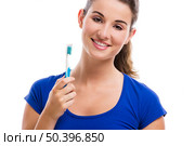 Beautiful woman with a great smile holding toothbrush, isolated over a white background. Стоковое фото, агентство Ingram Publishing / Фотобанк Лори