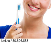 Beautiful woman with a great smile holding toothbrush, isolated over a white background. Стоковое фото, агентство Ingram Publishing / Фотобанк Лори