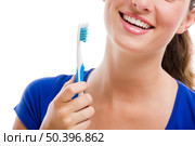 Beautiful woman with a great smile holding toothbrush, isolated over a white background. Стоковое фото, агентство Ingram Publishing / Фотобанк Лори