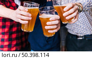 close up friends hand clinking beer glasses. Стоковое фото, агентство Ingram Publishing / Фотобанк Лори
